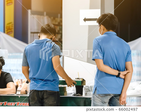 Back view of men order pizza to take home inside of department store closed due to the corona virus (Covid-19) outbreak but opens only food section 66002497