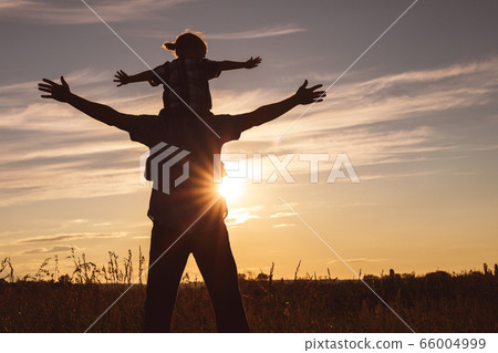 Father and son playing in the park at the sunset Father and son playing in the park at the sunset 66004999