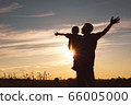 Father and son playing in the park at the sunset 66005000
