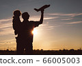 Father and son playing in the park at the sunset 66005003