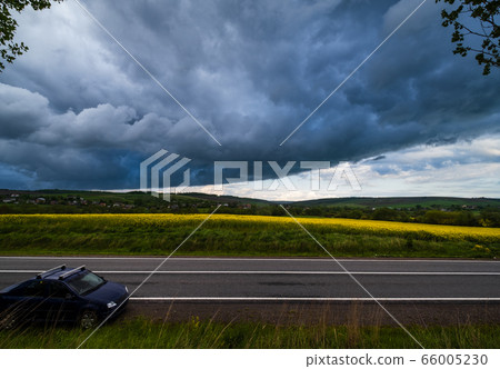 Dramatic thunderstorm cloud over countryside and Dramatic thunderstorm cloud over countryside and 66005230