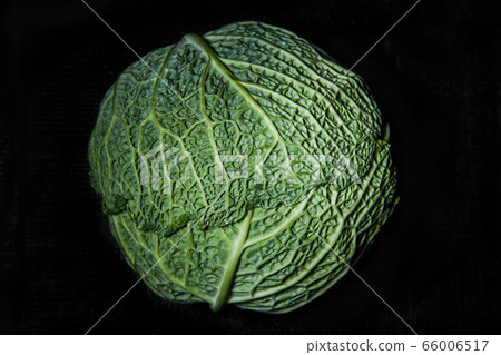 Savoy cabbage on a dark background close-up. Leaf, agriculture. 66006517