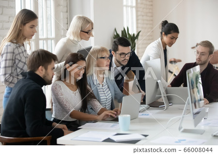 Focused company workers analyzing financial marketing reports. 66008044
