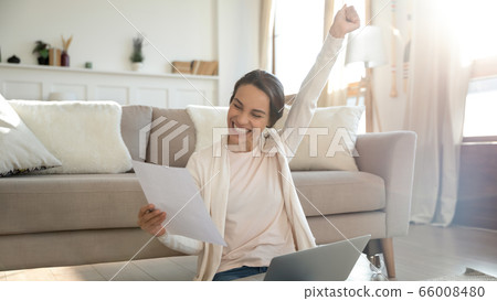 Excited young woman get good news in paper letter 66008480