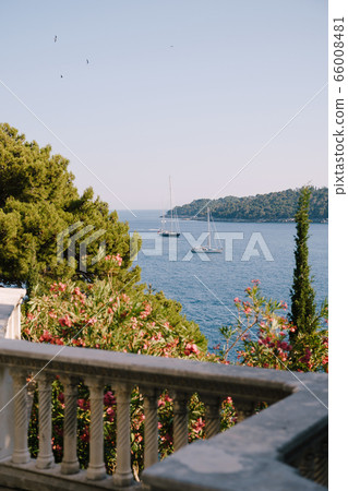 Lokrum is a small island in the Adriatic Sea, near Dubrovnik, Croatia. The view from the window of an old hotel on the nearby ships, yachts and boats. Lokrum is a small island in the Adriatic Sea, near Dubrovnik, Croatia. The view from the window of an old hotel on the nearby ships, yachts and boats. 66008481
