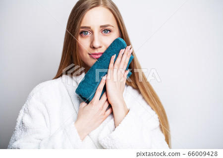 Face care, beautiful woman wipes her face with a towel after taking a shower Face care, beautiful woman wipes her face with a towel after taking a shower 66009428