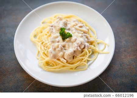 Spaghetti italian pasta served on white plate with 66012196