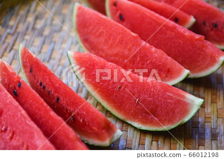watermelon slice on wood background - close up 66012198
