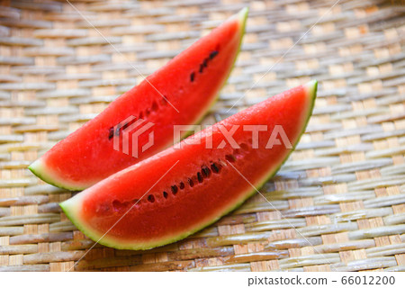 watermelon slice on wood background - close up watermelon slice on wood background - close up 66012200
