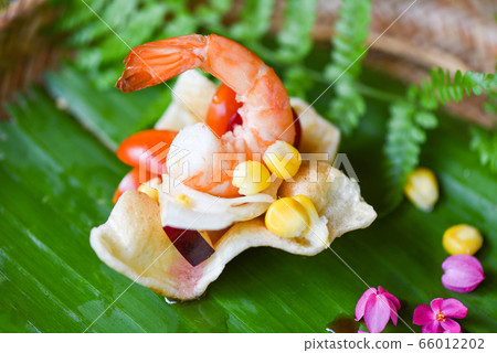 shrimp salad corn and sauce on prawn crackers with shrimp salad corn and sauce on prawn crackers with 66012202