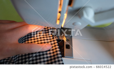 Hands of high school boys sewing 66014522