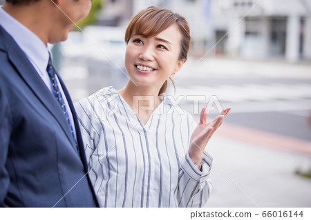 Asian woman communicating in English (interpreter/translator) Asian woman communicating in English (interpreter/translator) 66016144