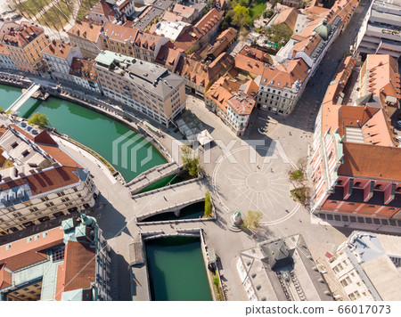 Aerial drone view of Preseren Squere and Triple Bridge over Ljubljanica river,Tromostovje, Ljubljana, Slovenia. Empty streets during corona virus pandemic social distancing measures 66017073