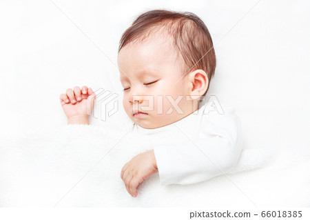 Newborn sleeping on the white bed (isolated on Newborn sleeping on the white bed (isolated on 66018385