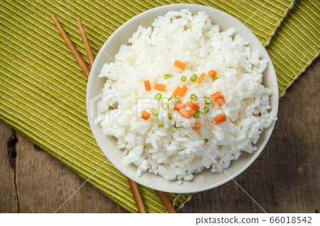 Jasmine rice with chopsticks on a fabric mat 66018542