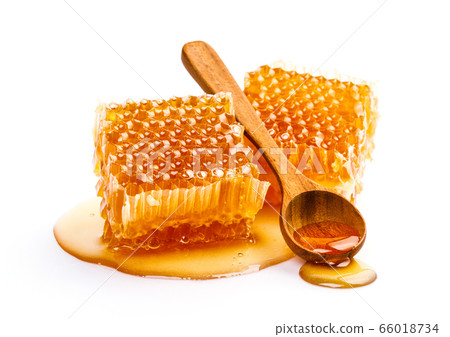 Honeycomb with honey spoon isolated on white background 66018734