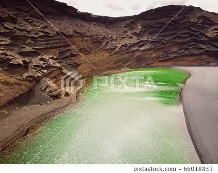 Volcanic crater with a green lake near El Golfo in Lanzarote island, Spain Volcanic crater with a green lake near El Golfo in Lanzarote island, Spain 66018831