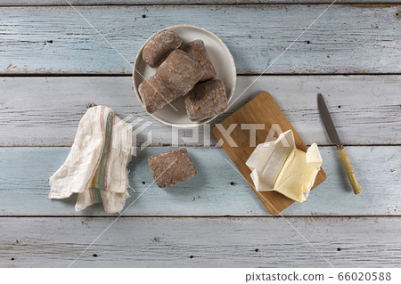 Fresh buns of gray flour with butter on a blue Fresh buns of gray flour with butter on a blue 66020588