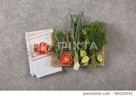 Cucumbers tomatoes greens vegetarian food on a 66020591