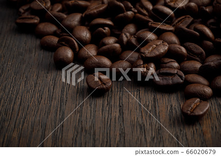 The hot of brown roasted coffee beans on brown background with copyspace, Healthy products by organic natural ingredients concept The hot of brown roasted coffee beans on brown background with copyspace, Healthy products by organic natural ingredients concept 66020679