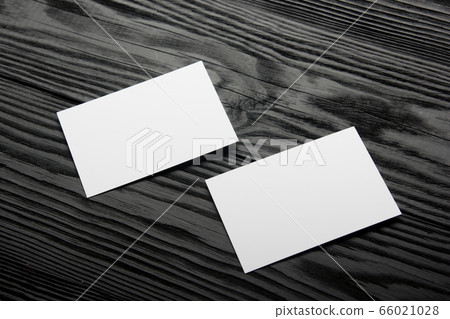 Business card blank on black wooden background. Corporate Stationery, Branding Mock-up. Creative designer desk. Flat lay. Copy space for text 66021028