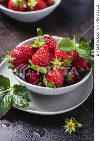 Fresh strawberry with a green leaves Fresh strawberry with a green leaves 66021212