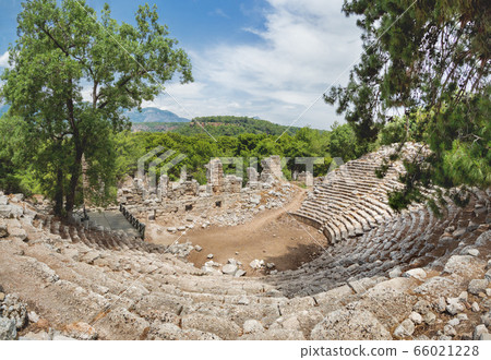 Ruins of amphitheatre of ancient Phaselis city. Panorama view on famous architectural landmark, Kemer district, Antalya province. Turkey. Ruins of amphitheatre of ancient Phaselis city. Panorama view on famous architectural landmark, Kemer district, Antalya province. Turkey. 66021228