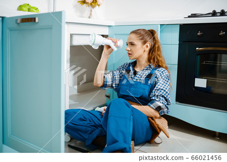 Female plumber fixing problem with drain pipe Female plumber fixing problem with drain pipe 66021456