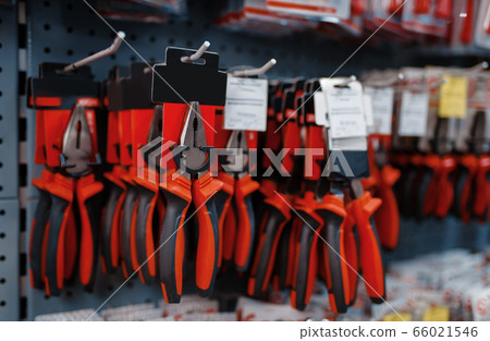 Pliers on racks in tool store closeup, nobody 66021546