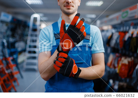 Male worker hands in protective gloves, tool store Male worker hands in protective gloves, tool store 66021632