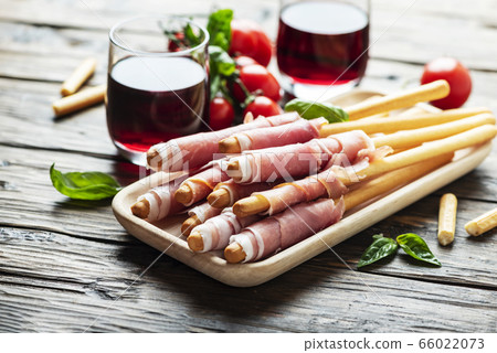 Italian antipasto with brad sticks and pork ham 66022073