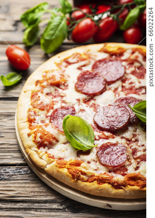 Italian pizza with tomato and salami Italian pizza with tomato and salami 66022264