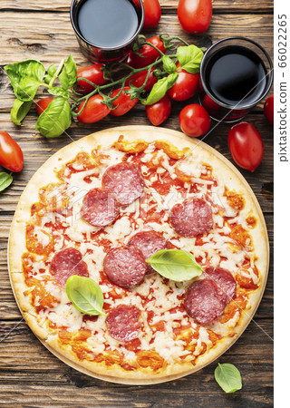 Italian pizza with tomato and salami Italian pizza with tomato and salami 66022265