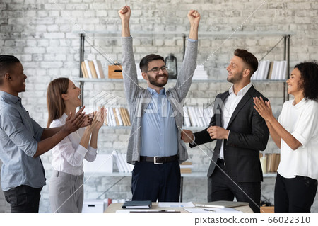 Diverse employees congratulating successful colleague with promotion 66022310