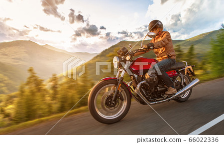 Motorcycle driver riding in Alpine highway, Motorcycle driver riding in Alpine highway, 66022336