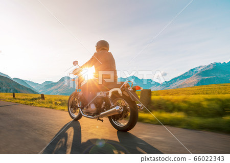 Motorcycle driver riding in Alpine highway, Motorcycle driver riding in Alpine highway, 66022343