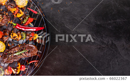 Barbecue grill with beef steaks, close-up. 66022367