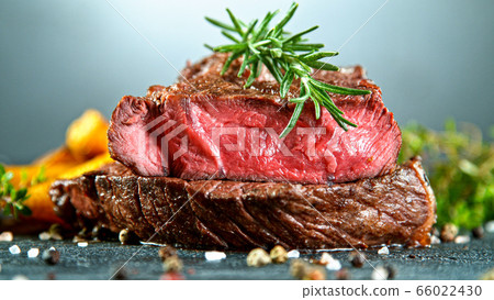 Close-up of tasty beef steak on black stone table 66022430