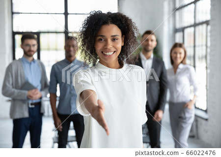 Head shot portrait smiling African American businesswoman offering handshake 66022476