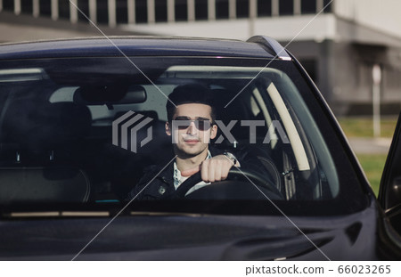 businessman is sitting in luxury car businessman is sitting in luxury car 66023265