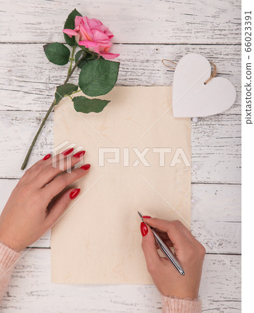 Empty blank paper with woman's hands. Background 66023391