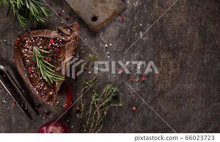 Grilled beef steak on black stone table. 66023723