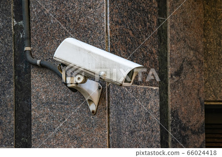 close-up of a surveillance camera in front of a 66024418