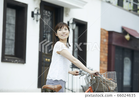 Woman riding a bicycle Woman riding a bicycle 66024635
