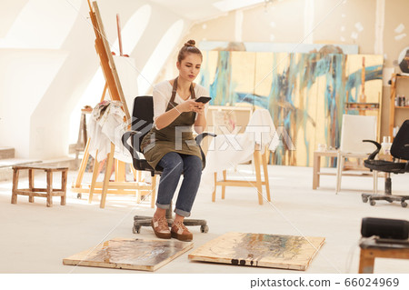 Female Artist Taking Photos of Paintings in Studio Female Artist Taking Photos of Paintings in Studio 66024969