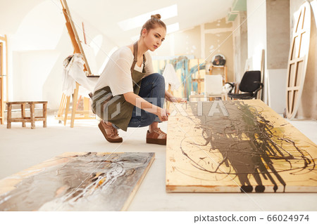 Female artist Working on Abstract Painting 66024974