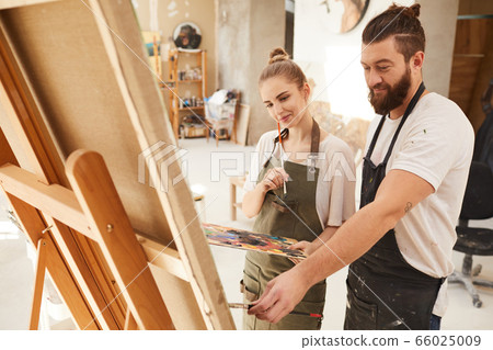 Smiling Creative Couple Painting Picture Together 66025009