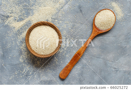 Raw uncooked fonio seeds grey background 66025272