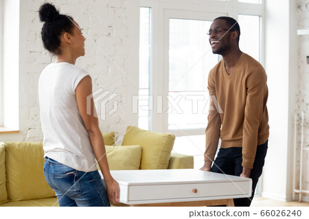 African couple placing new furniture moving at new home 66026240