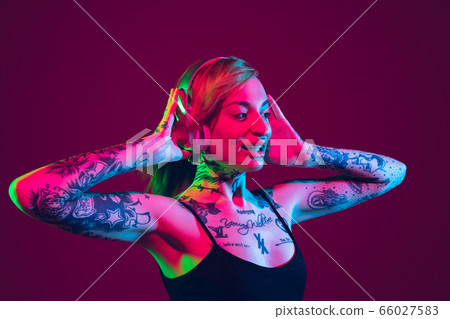 Portrait of young caucasian woman on purple background with copyspace, unusual and freaky appearance 66027583